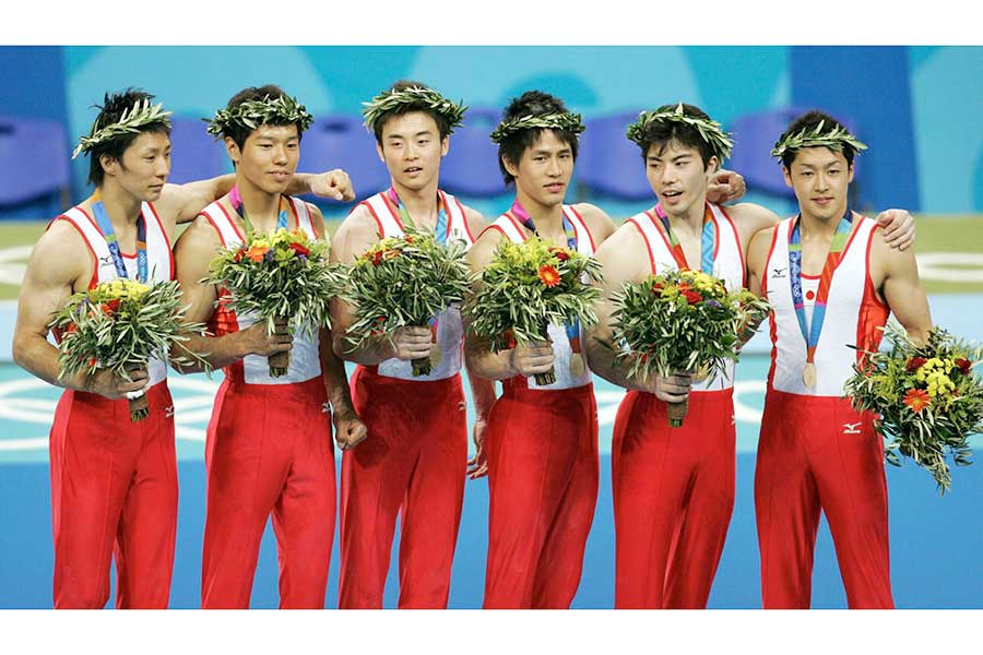 アテネ五輪男子団体で金メダルを獲得した塚原さん（右から2人目）【写真：Getty Images】