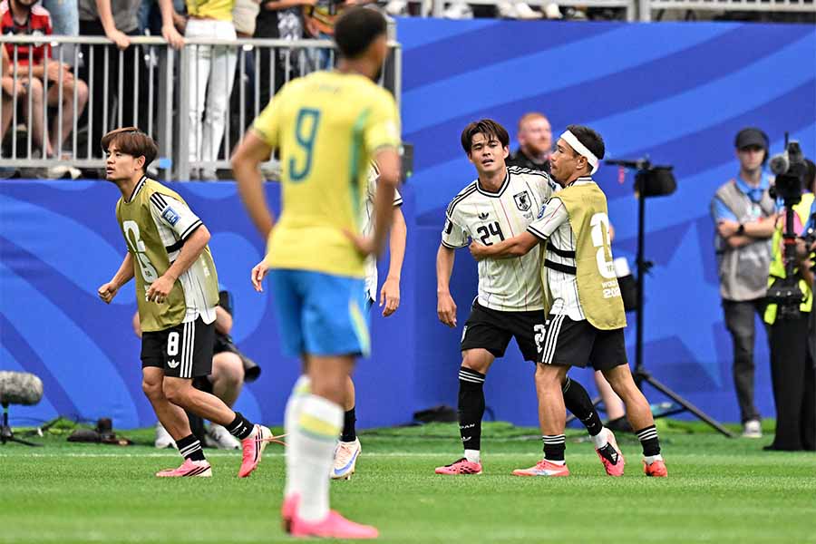 佐野の先制点に歓喜する日本代表【写真：ロイター】